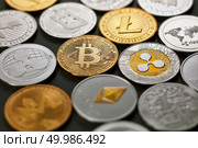 Collection from different coins of crypto currency, pattern from a ethereum, litecoin, bitcoin, monero, ripple, dash on dark background. Cryptocurrency and blockchain trading concept.. Pattern of coins LTC, ETH, BTC, XMR, XRP on a dark background. Business concept. Стоковое фото, агентство Ingram Publishing / Фотобанк Лори