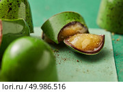 green candy cane cut on a green background. green chocolate candy with jelly. Стоковое фото, агентство Ingram Publishing / Фотобанк Лори