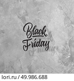 Calligraphic text Black Friday on a gray concrete background. The concept of sale, copy space. concept of sales, black Friday. Стоковое фото, агентство Ingram Publishing / Фотобанк Лори
