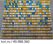 KIEV, UKRAINE - July 19, 2018. National Sports Complex Olimpiysky, aerial view from drone to a tribune with blue and yellow colors in a summer time before match.. KIEV, UKRAINE - July 19, 2018.Panoramic view from drone of tribunes with yellow and blue seats of National Sports Complex Olimpiysky on a summer day at sunset. Редакционное фото, агентство Ingram Publishing / Фотобанк Лори