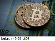 Gold coin Bitcoins, and Euro banknote. Cryptocurrency and blockchain concept, Business and investment concept.. Gold coin Bitcoins, and Euro banknote Cryptocurrency. Стоковое фото, агентство Ingram Publishing / Фотобанк Лори