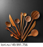 Wooden spoons and knife on black background. Wooden spoons and knife. Стоковое фото, агентство Ingram Publishing / Фотобанк Лори