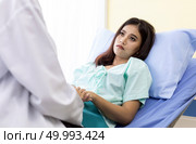 Patient fell worry when Asian Doctor make routine health check in hospital ward. Стоковое фото, агентство Ingram Publishing / Фотобанк Лори