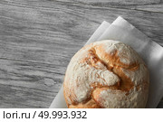 Homemade rye artisan sourdough bread over white wooden background. Top view of bread represented on cooking paper. Blank copy space for noting your ideas and emotions.. Homemade rye artisan sourdough bread. Стоковое фото, агентство Ingram Publishing / Фотобанк Лори
