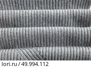natural warm knitted gray fabric with fabric folds. natural warm knitted gray fabric. Стоковое фото, агентство Ingram Publishing / Фотобанк Лори