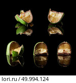 different sized green candies in a cut on a black background. section of delicious chocolates candies. Стоковое фото, агентство Ingram Publishing / Фотобанк Лори