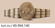 Cryptocurrency physical gold bitcoin coin and Stacks of bitcoins standing against a beige background. Cryptocurrency and blockchain trading concept. Can be used for video or site cover. Cryptocurrency physical bitcoin gold coin and stacks of coins on backgound. Стоковое фото, агентство Ingram Publishing / Фотобанк Лори