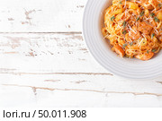Spaghetti bolognese pasta with tomato sauce, vegetables and chicken meat on white wooden rustic background. Traditional italian food. Top view. Flat lay. Стоковое фото, агентство Ingram Publishing / Фотобанк Лори