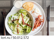 Caesar salad served with crispy bacon and poach egg. Стоковое фото, агентство Ingram Publishing / Фотобанк Лори