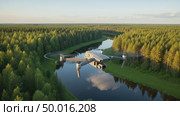 Drone flying above a winding river through a dense forest, untouched by human hand, without signs of civilization. Aerial photography of natural landscape with remote controlled quadcopter. Стоковое AI-видео, аниматор Ольга Яковенко / Фотобанк Лори