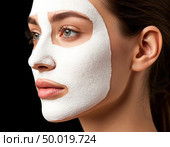 Cosmetic fabric mask on a woman's face. Стоковое AI-изображение, AI-художник Анна Никонорова / Фотобанк Лори