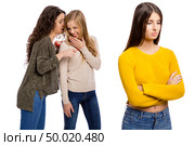 Teenagers making gossip from other girl. Стоковое фото, агентство Ingram Publishing / Фотобанк Лори