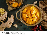 Chicken masala curry, spicy meat. Yellow chicken curry sauce. Spicy chicken curry dish. Traditional indian food, asian cuisine. Top view. Стоковое фото, агентство Ingram Publishing / Фотобанк Лори
