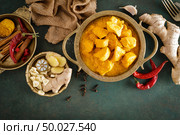 Chicken masala curry, spicy meat. Yellow chicken curry sauce. Spicy chicken curry dish. Traditional indian food, asian cuisine. Top view. Стоковое фото, агентство Ingram Publishing / Фотобанк Лори