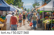 A diverse group of individuals walking through a bustling market, browsing stalls and interacting with local vendors. Стоковое AI-изображение, AI-художник Данила Большаков / Фотобанк Лори