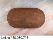 Top view of wooden cutting board on a gray marble background with space for text. Стоковое фото, агентство Ingram Publishing / Фотобанк Лори