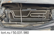 The car was seriously damaged as a result of a recent collision and a traffic accident. This close-up image shows a car with extensive damage to the front as a result of a serious accident. Стоковое видео, видеограф worker / Фотобанк Лори