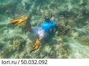 snorkeling diver make a free diving on tropical reef with blue background and reef fish in andaman sea indian ocean Thailand. Стоковое фото, агентство Ingram Publishing / Фотобанк Лори