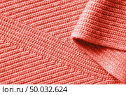 Winter warm scarf clothing background of knitted cotton fabric with folds in a color of the year 2019 Living Coral Pantone.. Background of the knitted fabric in a color of the year 2019 Living Coral Pantone. Стоковое фото, агентство Ingram Publishing / Фотобанк Лори