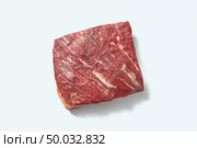 Natural fresh organicraw veal for cooking with shadows on a white background, place for text. Top view.. Fresh organic raw meat for roasting with shadows on a white background, copy space. Flat lay. Стоковое фото, агентство Ingram Publishing / Фотобанк Лори