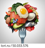 Eating ketogenic food and Keto nutrition lifestyle diet low carb and high fat meal as fish nuts eggs meat avocado and other healthy ingredients as a therapeutic snacks on a fork with 3D illustration elements. Стоковое фото, агентство Ingram Publishing / Фотобанк Лори