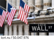 Wall street sign with New York Stock Exchange background New York City, New York, USA. Стоковое фото, агентство Ingram Publishing / Фотобанк Лори