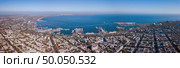 View of the Black Sea with the port and part of the city of Odessa against the blue sky on a summer day. Aerial view from the drone. Panorama of the city of Odessa and the sea with a port against a blue sky on a sunny day. Aerial view from the drone. Стоковое фото, агентство Ingram Publishing / Фотобанк Лори