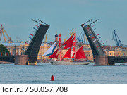 Russia, St.Petersburg, 12 June 2023: Sailing ship with red sails on a surreal evening landscape, the brigantine goes along the embankment to the raised Palace Bridge, the Admiralty building. Редакционное фото, фотограф Vladimir Drozdin / Фотобанк Лори