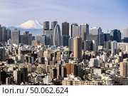 Mountain Fuji with Tokyo skylines and skyscrapers buildings in Shinjuku ward in Tokyo. Taken from Tokyo Bunkyo civic center observatory sky desk. Стоковое фото, агентство Ingram Publishing / Фотобанк Лори