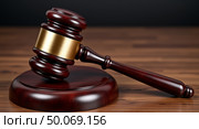 Polished wooden gavel and sound block on grainy wood surface symbolizing justice and authority in legal proceedings. Стоковое AI-изображение, AI-художник Андрей Бакусов / Фотобанк Лори