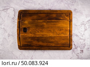 Top view of wooden cutting board on a gray marble background with space for text. Стоковое фото, агентство Ingram Publishing / Фотобанк Лори