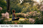 A woman is sitting in a park, surrounded by flowers and trees. Стоковое AI-изображение, AI-художник Ярославский Максим / Фотобанк Лори