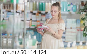 Selective pregnant woman customer choosing paracetamol pills in box in chemistry. Стоковое видео, видеограф Яков Филимонов / Фотобанк Лори
