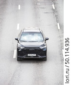 Chery Tiggo 9 car model on the highway in motion, aerial frontal view. Редакционное фото, фотограф Константин Григорьев / Фотобанк Лори