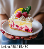 Close-up of dessert: The photo shows a delicious slice of cheesecake with raspberry sauce and fluffy whipped cream. The dessert is decorated with fresh raspberries, a lemon wedge and a green leaf. The slice is carefully served on a light ceramic plate, held in hands with manicured nails covered with dark red varnish. The atmosphere is warm and cozy, perfect for food blogs, cafe menus, dessert ads or gastronomic magazines. Стоковое AI-изображение, AI-художник Анна Кривицкая / Фотобанк Лори