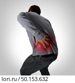 Painful back symptoms and lower spinal pain or backache and painful spine medical concept as a person holding the painful area as a medical concept as a composite image. Стоковое фото, агентство Ingram Publishing / Фотобанк Лори