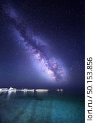 Night landscape with colorful Milky Way at the sea with stones. Starry sky. Space background. Стоковое фото, агентство Ingram Publishing / Фотобанк Лори
