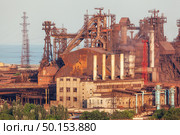 Rusty steel factory with smokestacks at sunset. metallurgical plant. steelworks, iron works. Heavy industry in Europe. Air pollution from smokestacks, ecology problems. Industrial landscape. Стоковое фото, агентство Ingram Publishing / Фотобанк Лори