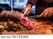 Chef cut Wagyu beef roast prime rib, Carving food. Стоковое фото, агентство Ingram Publishing / Фотобанк Лори