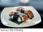 Unagi eel sushi, japanese food traditional cuisine, on white plate. Стоковое фото, агентство Ingram Publishing / Фотобанк Лори
