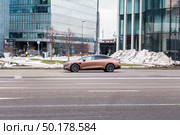 Zeekr 007 all electric car driving down the street. Редакционное фото, фотограф Константин Григорьев / Фотобанк Лори