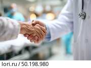 A doctor shakes hands with an elderly patient. Стоковое AI-изображение, AI-художник Ярославский Максим / Фотобанк Лори
