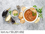Eggplant hummus with ingredients for cooking. Traditional vegan arabic aubergine appetizer. Baba Ghanoush. Стоковое фото, агентство Ingram Publishing / Фотобанк Лори