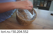 Woman reviewing souvenir wicker storage basket. Стоковое видео, видеограф Vadzim Yakubovich / Фотобанк Лори