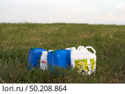 Russia, Naberezhnye Chelny, June 20, 2025: chemical weeding of a field. Use of herbicides in agriculture. Containers with a chemical preparation at the edge of a field after harvesting green fodder. Редакционное фото, фотограф Роман Дзюбало / Фотобанк Лори