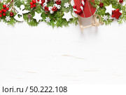 Christmas, New Year or Noel holiday festive winter greeting card with decorations, x-mas ornaments, stars, snowflakes and xmas bells on white background, flat lay composition, top view, copy space. Стоковое фото, агентство Ingram Publishing / Фотобанк Лори