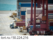 Working at Tshing yi Hong Kong Port for shipping and freight transportation and global business import and export background. Стоковое фото, агентство Ingram Publishing / Фотобанк Лори