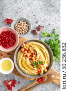 Chickpea hummus with tahini in a bowl. Healthy vegetarian appetizer. Middle Eastern cuisine. Стоковое фото, агентство Ingram Publishing / Фотобанк Лори