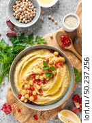 Chickpea hummus with tahini in a bowl. Healthy vegetarian appetizer. Middle Eastern cuisine. Стоковое фото, агентство Ingram Publishing / Фотобанк Лори