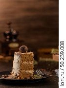 Slice of delicious naked coffee and hazelnuts cake on table rustic wood kitchen countertop. Стоковое фото, агентство Ingram Publishing / Фотобанк Лори